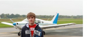 Picture of Jesse with his plane in the background
